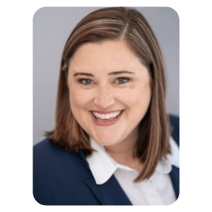 A headshot of Dr. Lauren Maltby.  She is smiling and wearing a navy blue business suit with a white collared shirt.
